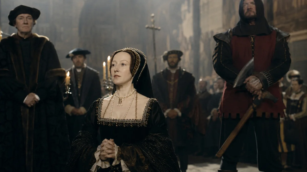 Anne Boleyn in a dark Tudor gown standing before an executioner holding an axe in a candlelit hall